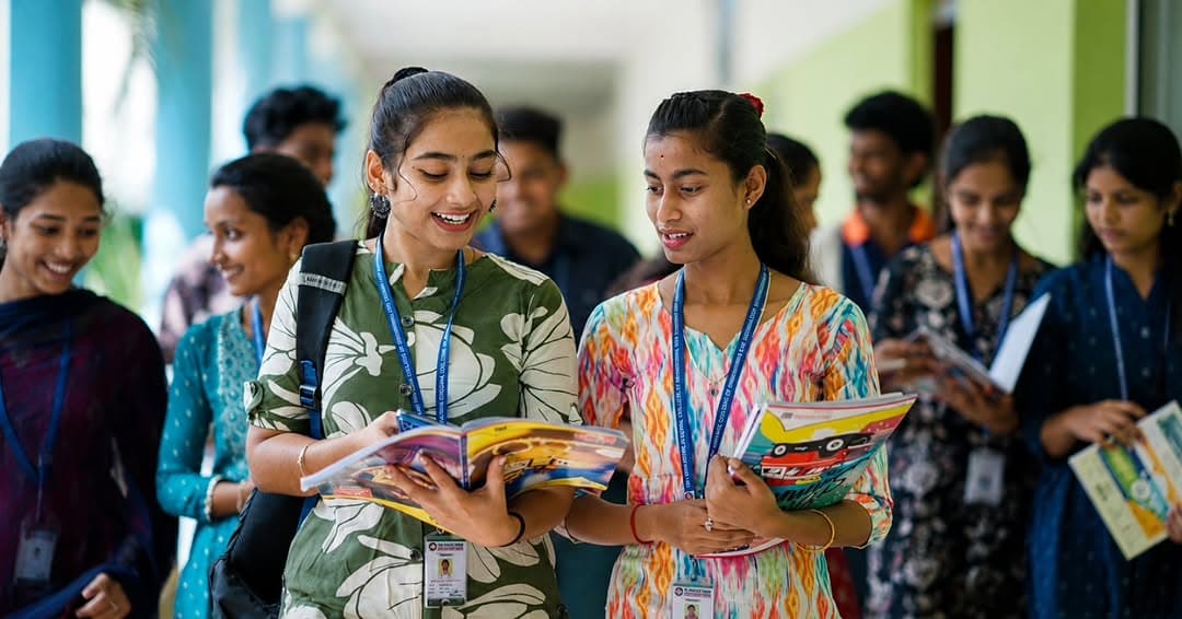 SVPP students reading a magazine together along a campus corridor